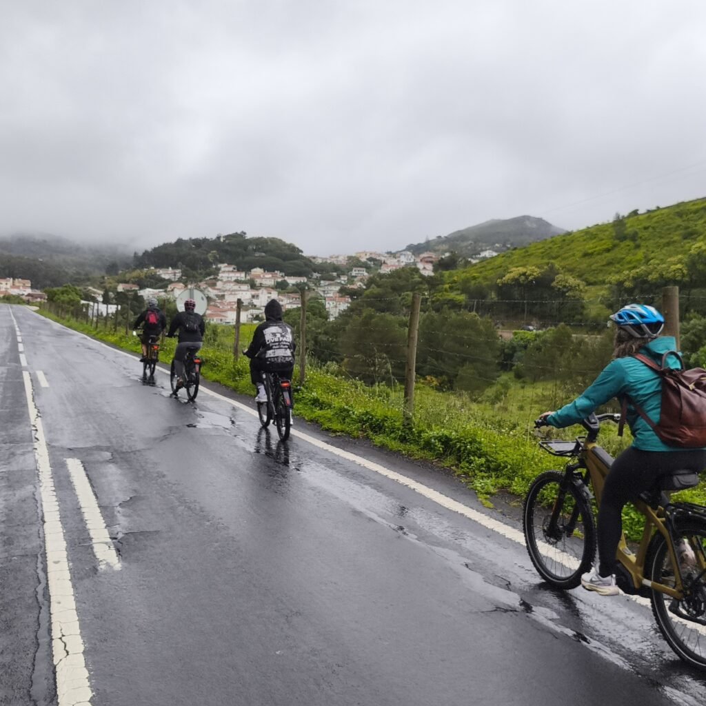 Group of cyclists enjoying wide views of the Atlantic Ocean on the Cascais Bike Ride.