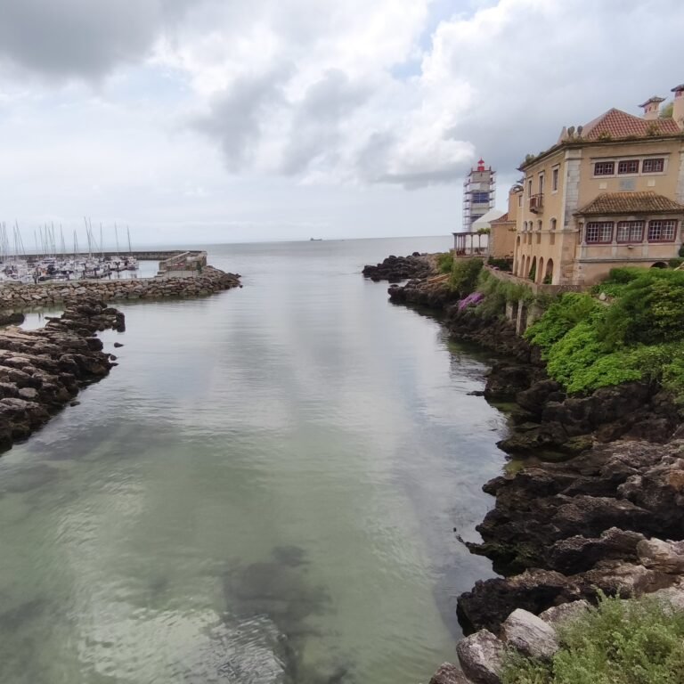 View of the Atlantic Ocean and rocky coast with turquoise water in Cascais.