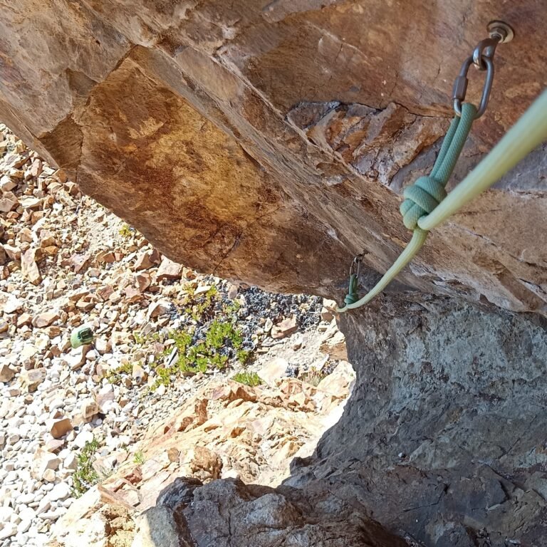Close-up of a rugged sea cliff with climbing gear, part of a Cascais adventure.