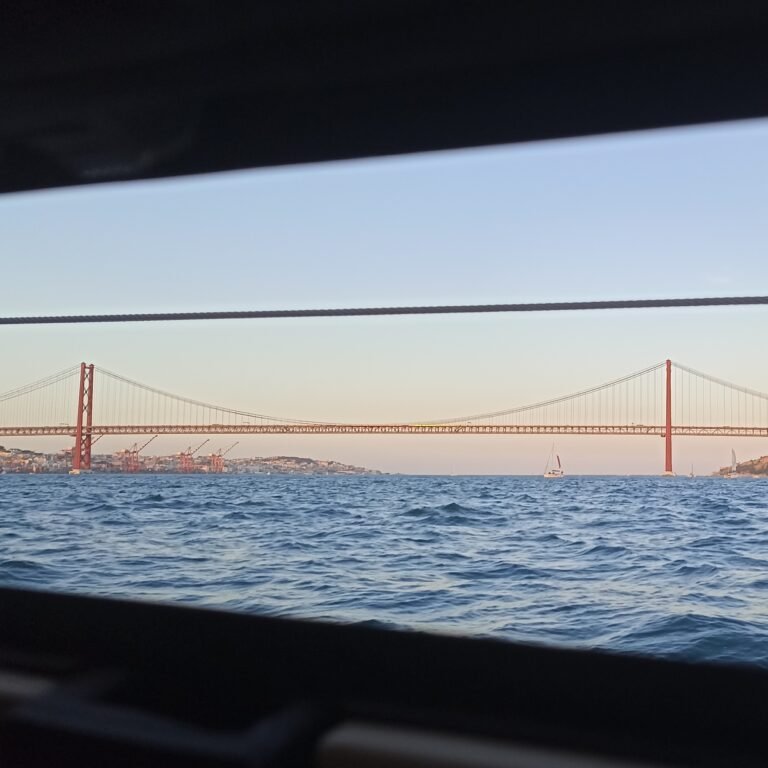 Side view of a sailboat's deck and rigging, indicating movement on the water.