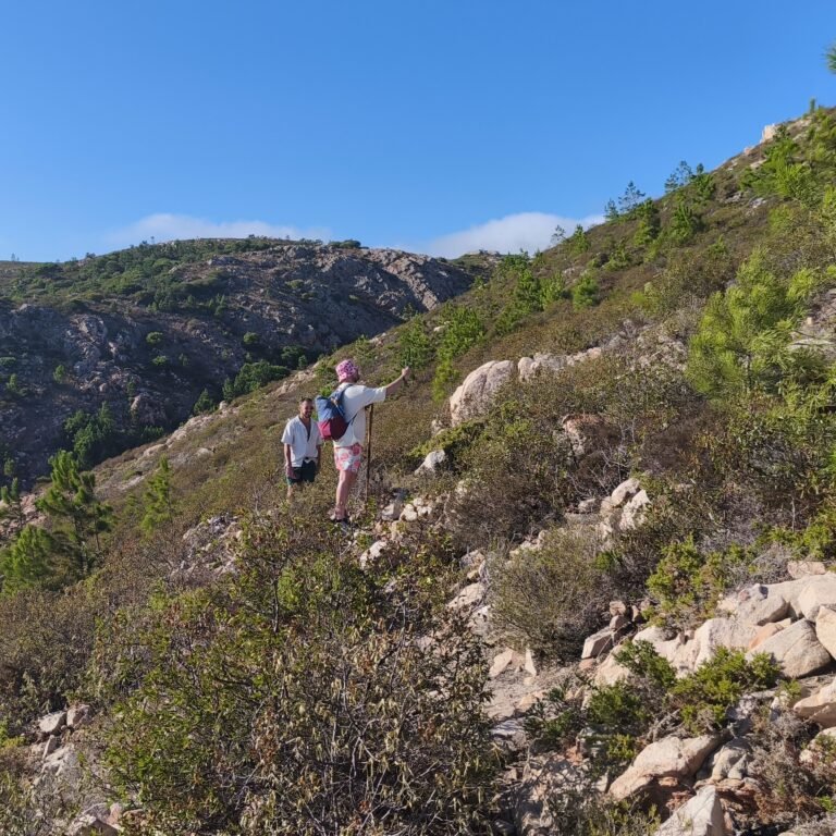 Hiker climbing near the Atlantic shoreline during the Atlantic Wild Hike adventure.