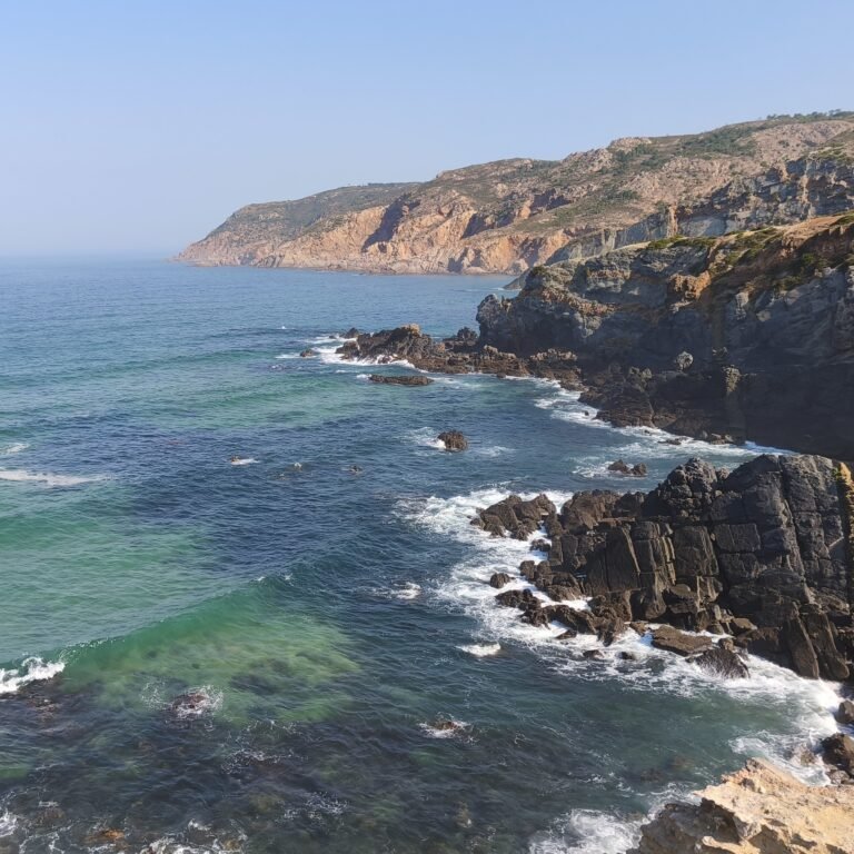 Wild rocky formations on the Sintra coast along the Atlantic Wild Hike route.