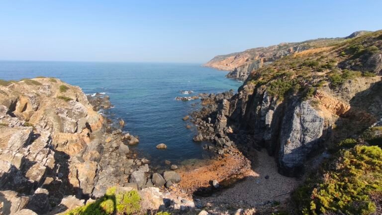 Adventurer navigating steep rocky terrain during the Atlantic Wild Hike.