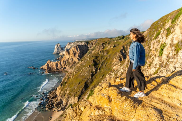 Smiling Young Girl Stands on Edge of Cabo da Roca - Westernmost Continental Europe Point